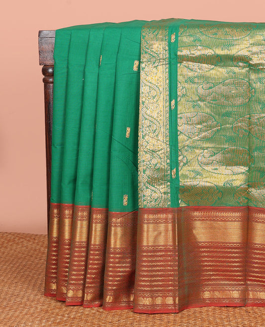 Green Chettinad Cotton Saree Enriched with Zari Buttas All Over Its Body, Complemented by Contrast Border Steeped with Traditional Zari Designs, Pallu of Paisley Designs, and Paired with a Matching Blouse