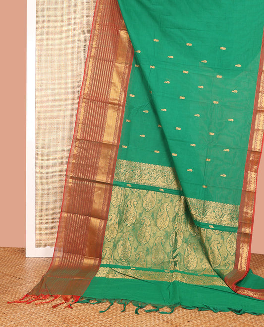 Green Chettinad Cotton Saree Enriched with Zari Buttas All Over Its Body, Complemented by Contrast Border Steeped with Traditional Zari Designs, Pallu of Paisley Designs, and Paired with a Matching Blouse