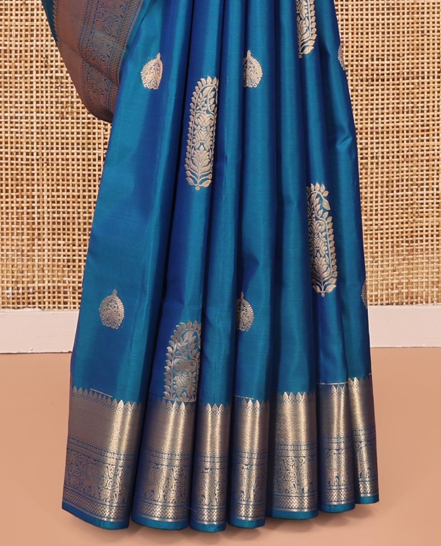 Blue Vasundhara Lite Silk Saree, Accentuated with Zari Buttas All Over Its Body, Highlighted by Zari Border of Thilakam, Mayil Kann, Kamalam, Rettai Neli, Yannai, and Vanki Designs, Delicately Woven Pallu and Paired with a Matching Blouse