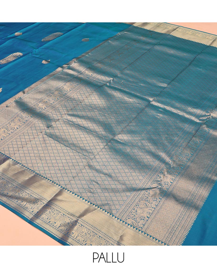 Blue Vasundhara Lite Silk Saree, Accentuated with Zari Buttas All Over Its Body, Highlighted by Zari Border of Thilakam, Mayil Kann, Kamalam, Rettai Neli, Yannai, and Vanki Designs, Delicately Woven Pallu and Paired with a Matching Blouse