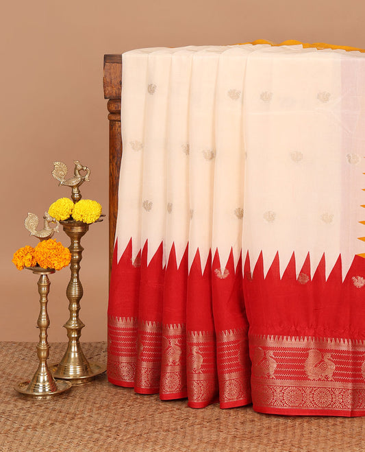 Cream with red small peacock butta muslin cotton saree with annam, temple border & ikkat design pallu along with zari motifs blouse