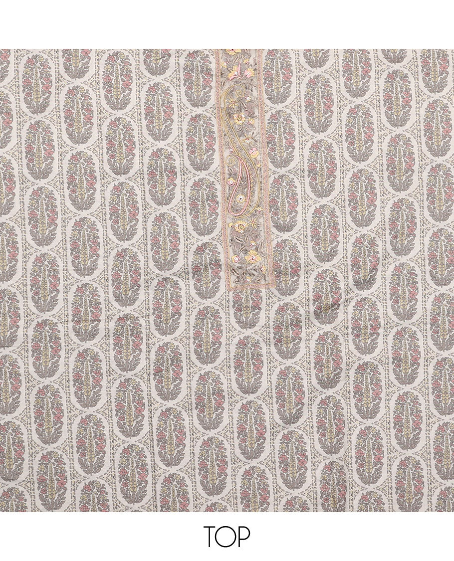 Peach  material chudidar set, intricately printed with neck work top, plain bottom, and floral motifs embroidered dupatta