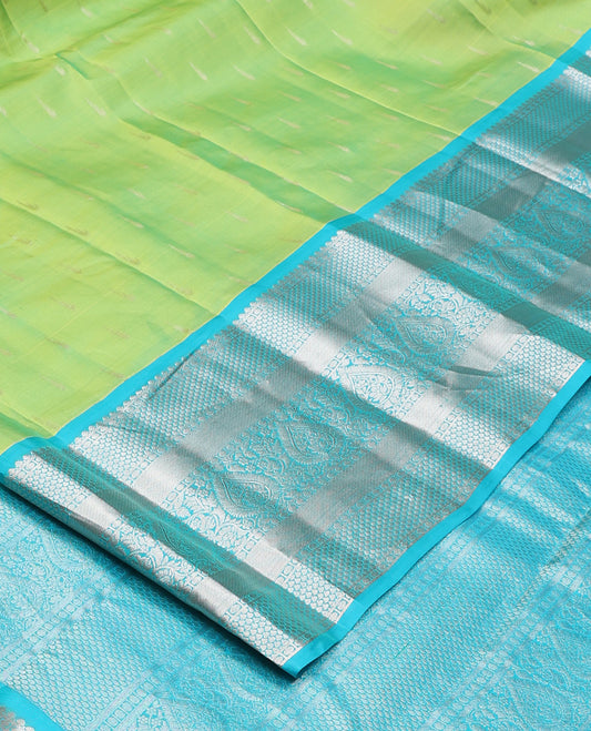 Parrot green muniya buttas Vasundhara silk mix, contrast border, and pallu of geometric zari designs