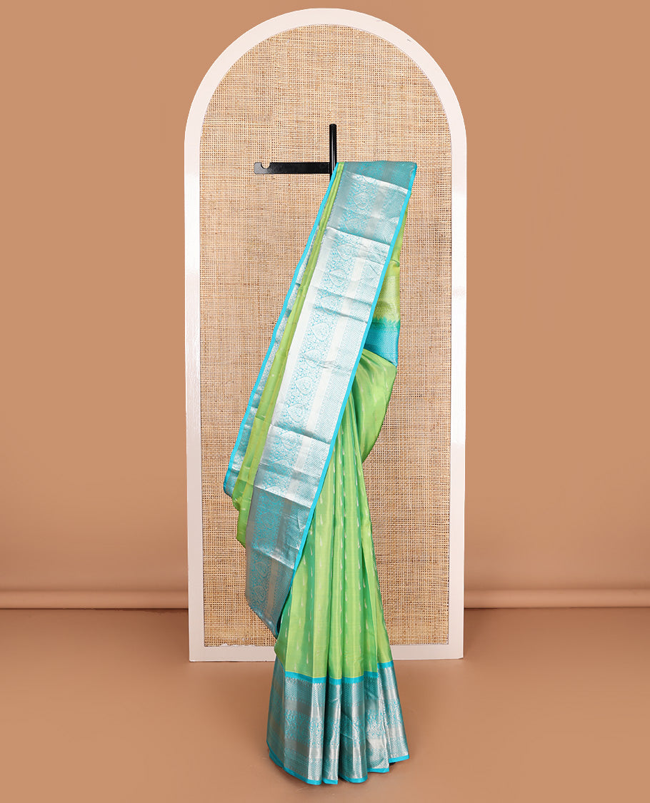 Parrot green muniya buttas Vasundhara silk mix, contrast border, and pallu of geometric zari designs