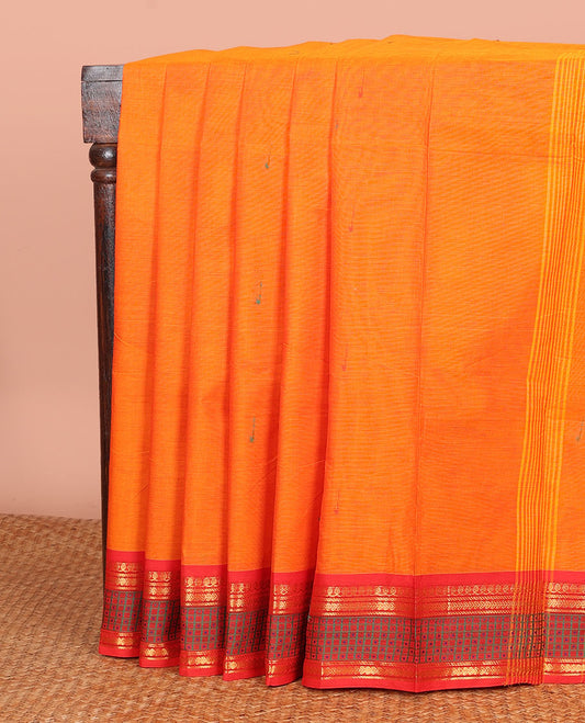 Orange Chettinad Cotton Saree Beautified with Buttas All Over Its Body, Complemented by Contrast Border Steeped with Traditional Designs, Pallu of Stripes and Buttas, and Paired with a Matching Blouse