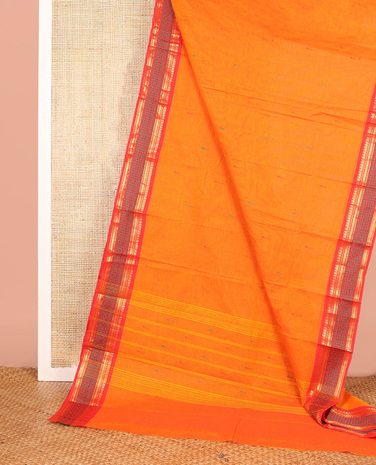 Orange Chettinad Cotton Saree Beautified with Buttas All Over Its Body, Complemented by Contrast Border Steeped with Traditional Designs, Pallu of Stripes and Buttas, and Paired with a Matching Blouse