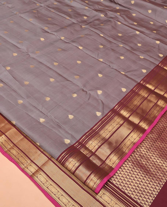 Grey Vasundhara Lite Silk Saree, Bedecked with Zari Buttas All Over Its Body, Complemented by Contrast Border of Rekku, Banaras, and Meen Designs, Grand Pallu and Paired with a Contrast Blouse
