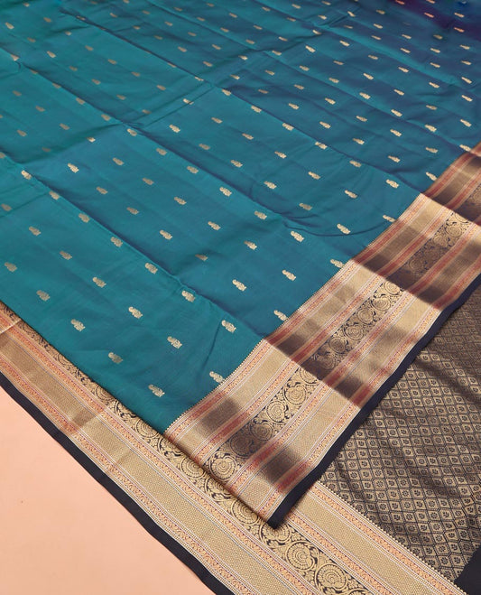 Blue Vasundhara Lite Silk Saree, Graced with Zari Buttas All Over Its Body, Complemented by Contrast Border of Mayil Kann and Dhavana Kodi Designs, Grand Jaal Pallu and Paired with a Contrast Blouse