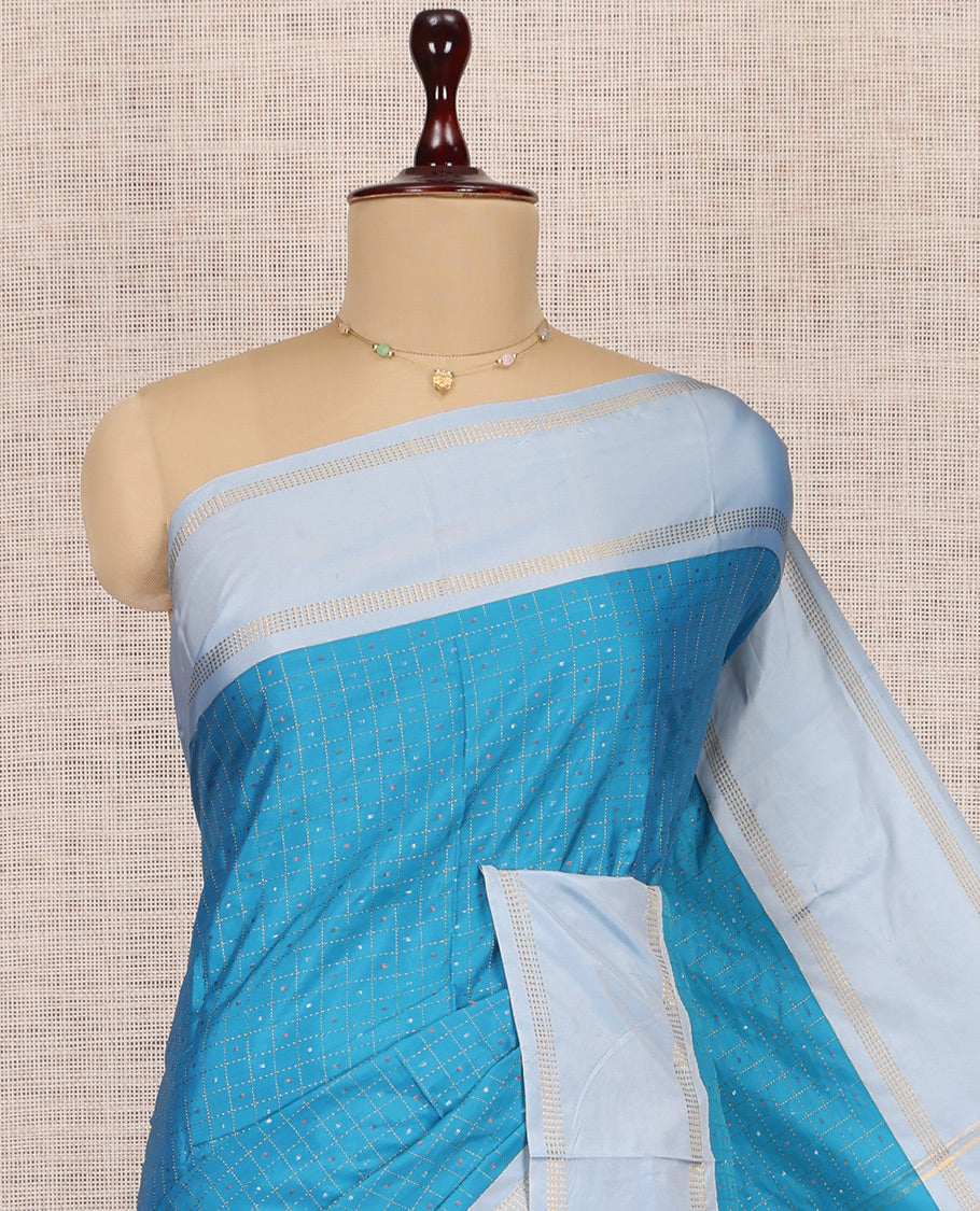 Blue Arani Saree, Features Zari Butta Enclosed Checks, a Contrast Bodi Border, Pallu of Zari Stripes, and a Matching Blouse