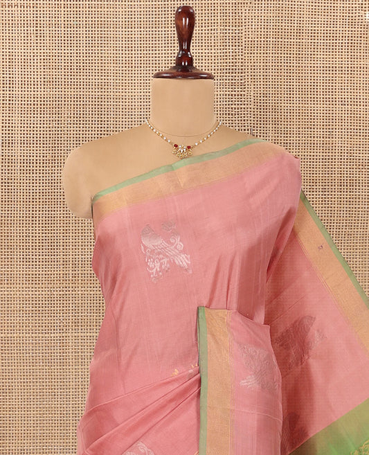 Pink Uppada Silk Saree Adorned with Parrot Zari Buttas, Complemented by Bavanji Border, Contrast Pallu Steeped with Parrot Zari Designs, and Paired with a Contrast Blouse
