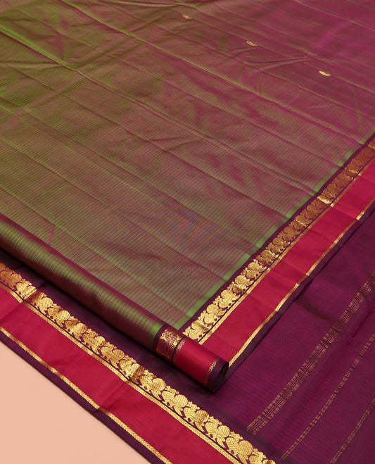 Green Kanchipuram Silk Saree, Sparsely Sparkled with Vazhaipoo Stripes and Zari Buttas on Its Body, Complemented by Contrast Rettai Pettu Border of Mayil, and Kathir Designs, Zari-Striped Pallu, and Paired with a Contrast Blouse