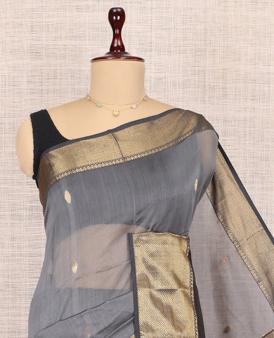 Grey Maheshwari Cotton Saree, Adorned with Buttas, Highlighted by a Traditional Zari Border, Pallu Gleamed Up with Zari Buttas, and a Contrast Blouse