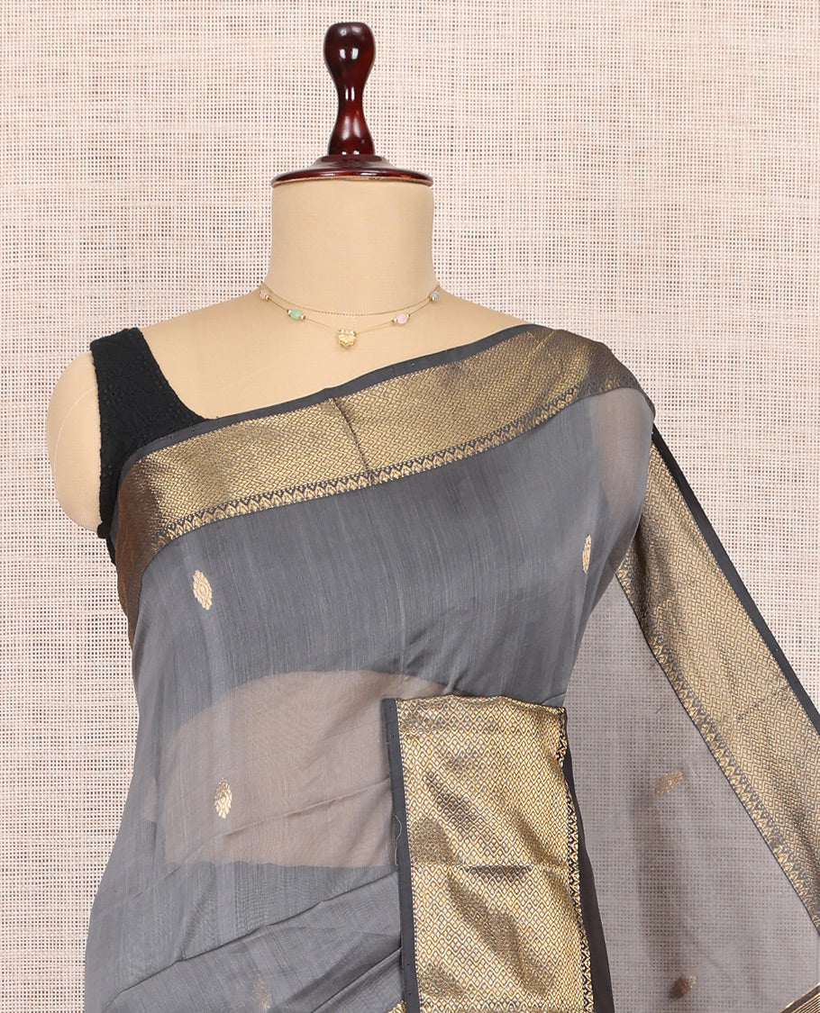 Grey Maheshwari Cotton Saree, Adorned with Buttas, Highlighted by a Traditional Zari Border, Pallu Gleamed Up with Zari Buttas, and a Contrast Blouse