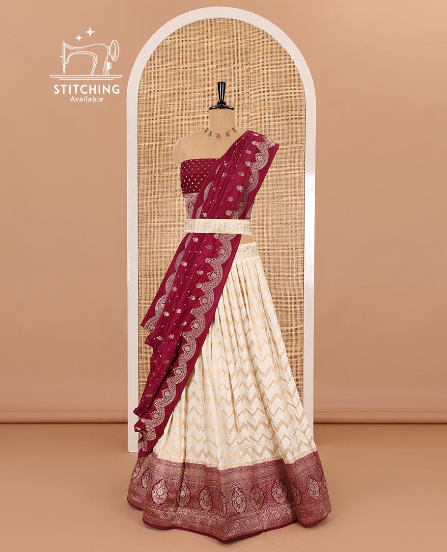 Cream-maroon chiniya crepe half-saree,  chevron zari jacquard with contrast intricate patterned stone work bordered skirt, contrast blouse, and a scallop bordered intricate dhavani
