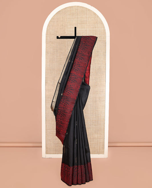Black Mayuri Soft Silk Saree, Adorned with Zari Buttas, a Self-Border, and a Pallu Features an Intricate Thread Weave, and a Matching Blouse