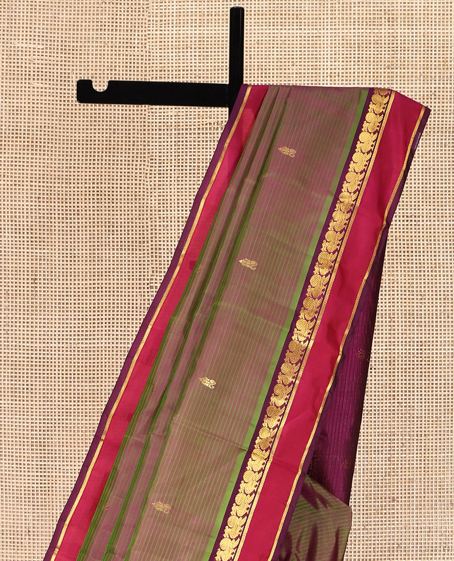 Green Kanchipuram Silk Saree, Sparsely Sparkled with Vazhaipoo Stripes and Zari Buttas on Its Body, Complemented by Contrast Rettai Pettu Border of Mayil, and Kathir Designs, Zari-Striped Pallu, and Paired with a Contrast Blouse