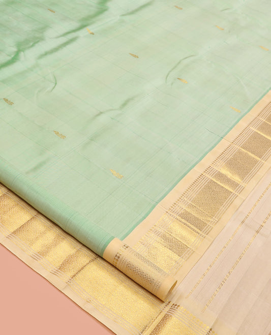Green Kanchipuram Silk Saree, Featuring Zari Buttas, a Contrast One-Sided Border of Panner Sombu, Muthu, Banaras, and Jaal Design, Zari Design Pallu, and No Blouse