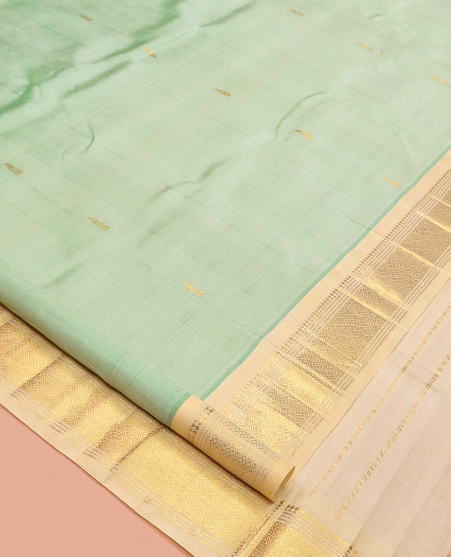 Green Kanchipuram Silk Saree, Featuring Zari Buttas, a Contrast One-Sided Border of Panner Sombu, Muthu, Banaras, and Jaal Design, Zari Design Pallu, and No Blouse