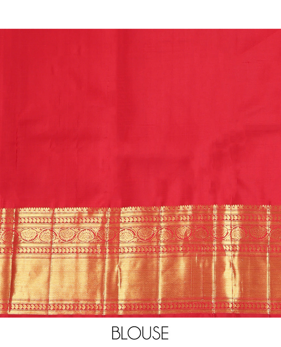 Red Kanchipuram Silk Saree, Subtly Sparkled with Zari Buttas All Over Its Body, Highlighted by a Zari Border of Thilakam, Kathir, Manga, and Dhavana Kodi Designs, Pallu of Jaal and Mayil Designs, and Paired with a Matching Blouse