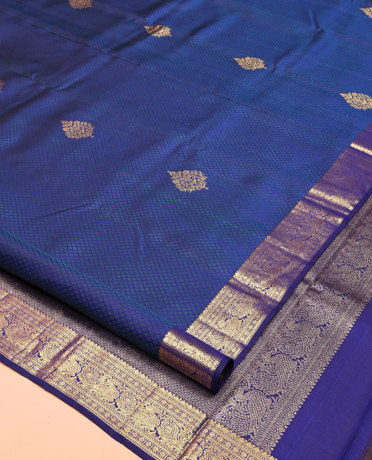 Blue Parampara Silk Saree, Graced with Zari Buttas and Embossed Texture On Its Body Highlighted by Zari Border of Muthu, Poun, and Mayil Designs, Pallu of Ara Maadam Designs, and Paired with a Matching Blouse