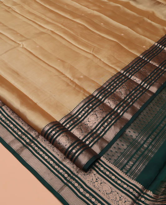Gold Vasundhara Silk Saree, Bedecked with Zari Buttas All Over Its Body, Complemented by a Contrast  Border of Rekku, Muthu, Kathir, Poun, Mayil, and Mayil Kann Designs, Grand Jaal Pallu, and Paired with a Contrast Blouse