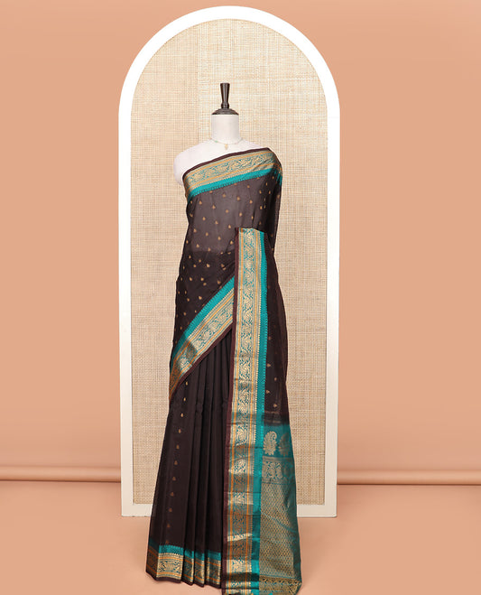 Brown Gadwal Saree Adorned with All-Over Buttas, Contrast Border Features Traditional Motifs, Pallu Elevated with Zari, and a Contrast Blouse of Zari Border