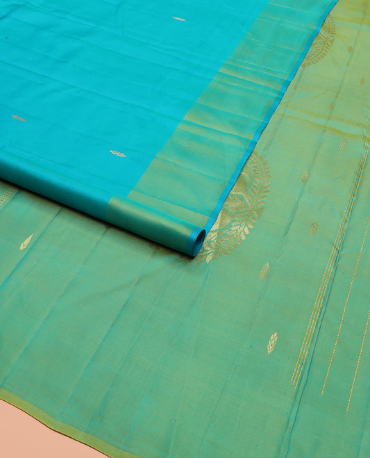 Blue Kanchipuram Silk Saree Subtly Sparkled with Zari Buttas, Complemented by a Contrast Border of Floral Zari Designs, Pallu Delicately Woven with Floral-Paisley Designs, and Paired with a Contrast Blouse