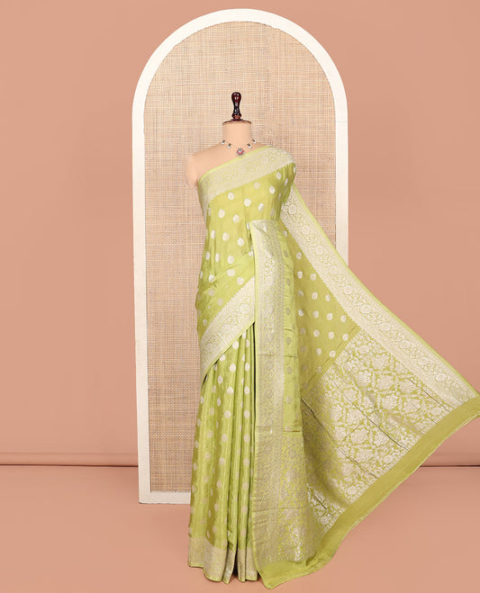 Green Fancy Crepe Saree, Gleamed Up with Thilakam Buttas, Highlighted by a Traditional Border, Intricately Designed Pallu, and a Matching Blouse