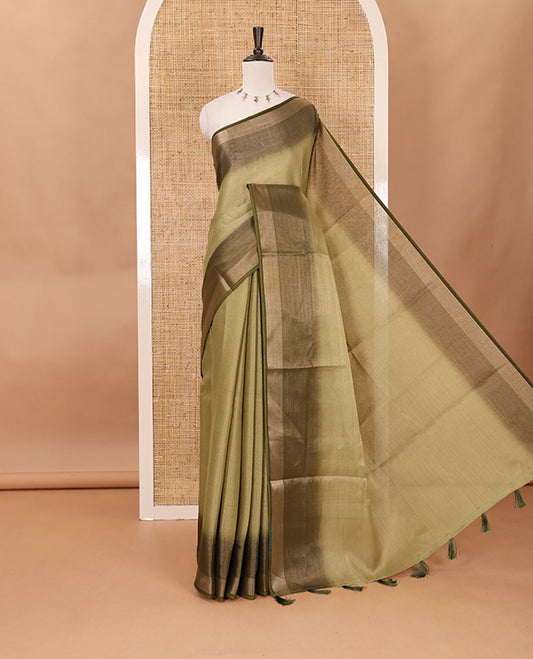 Olive green plain tissue saree, contrast gold zari piping border & self pallu with tussels
