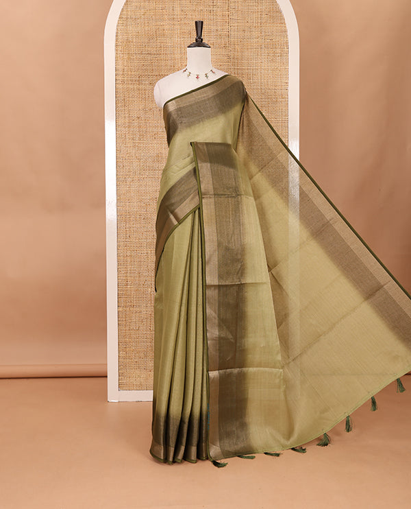 Olive green plain tissue saree, contrast gold zari piping border & self pallu with tussels