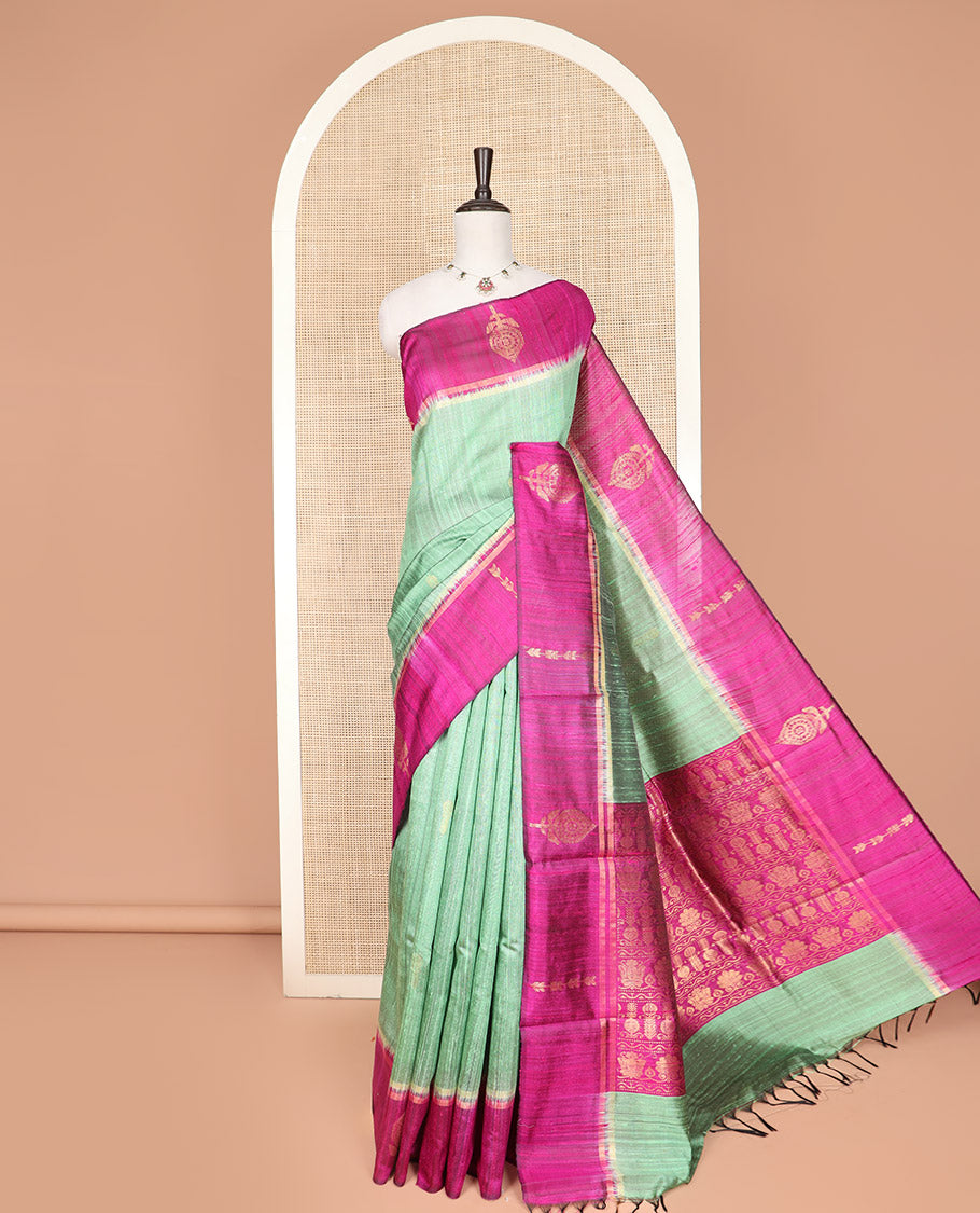 Green Dupion Silk Saree, Charmingly Accented with Buttas on Its Body, Complemented by a Contrast Border of Floral-Style Motifs, Intricately Designed Pallu, and Paired with a Contrast Blouse