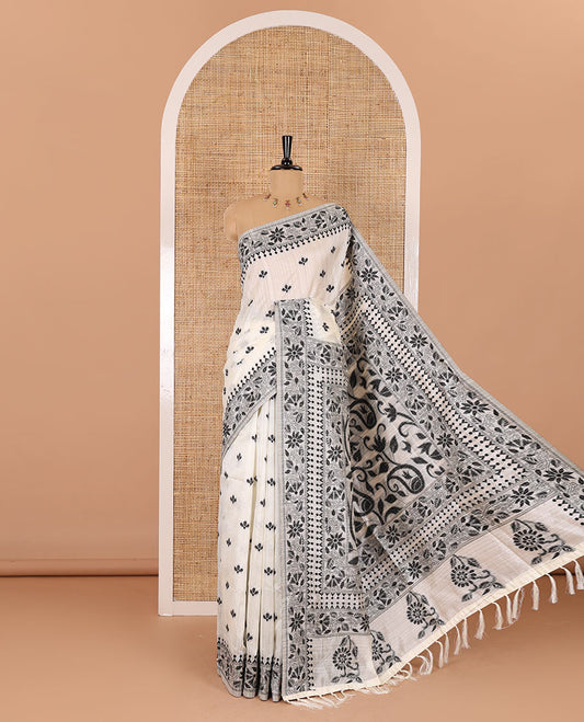 Half-white and black floral thread buttas woven jute cotton saree, floral thread weave border, floral-paisley weave pallu, and a matching blouse