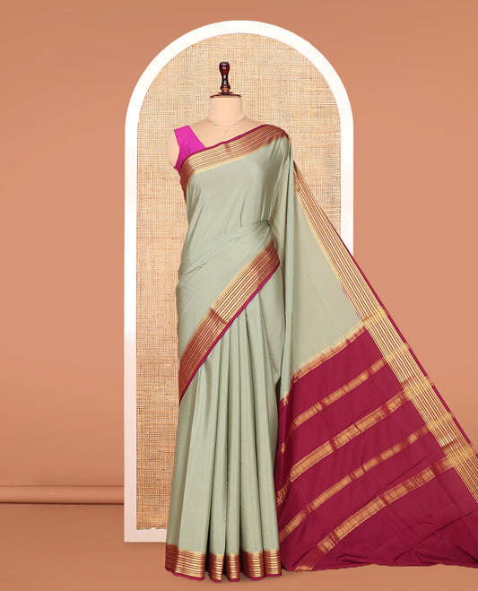 Green Plain Mysore Silk Saree Complemented by Captivating Contrast Traditional Zari Designs Woven Border, Gleaming Zari Striped Pallu and Paired with a Contrast Blouse