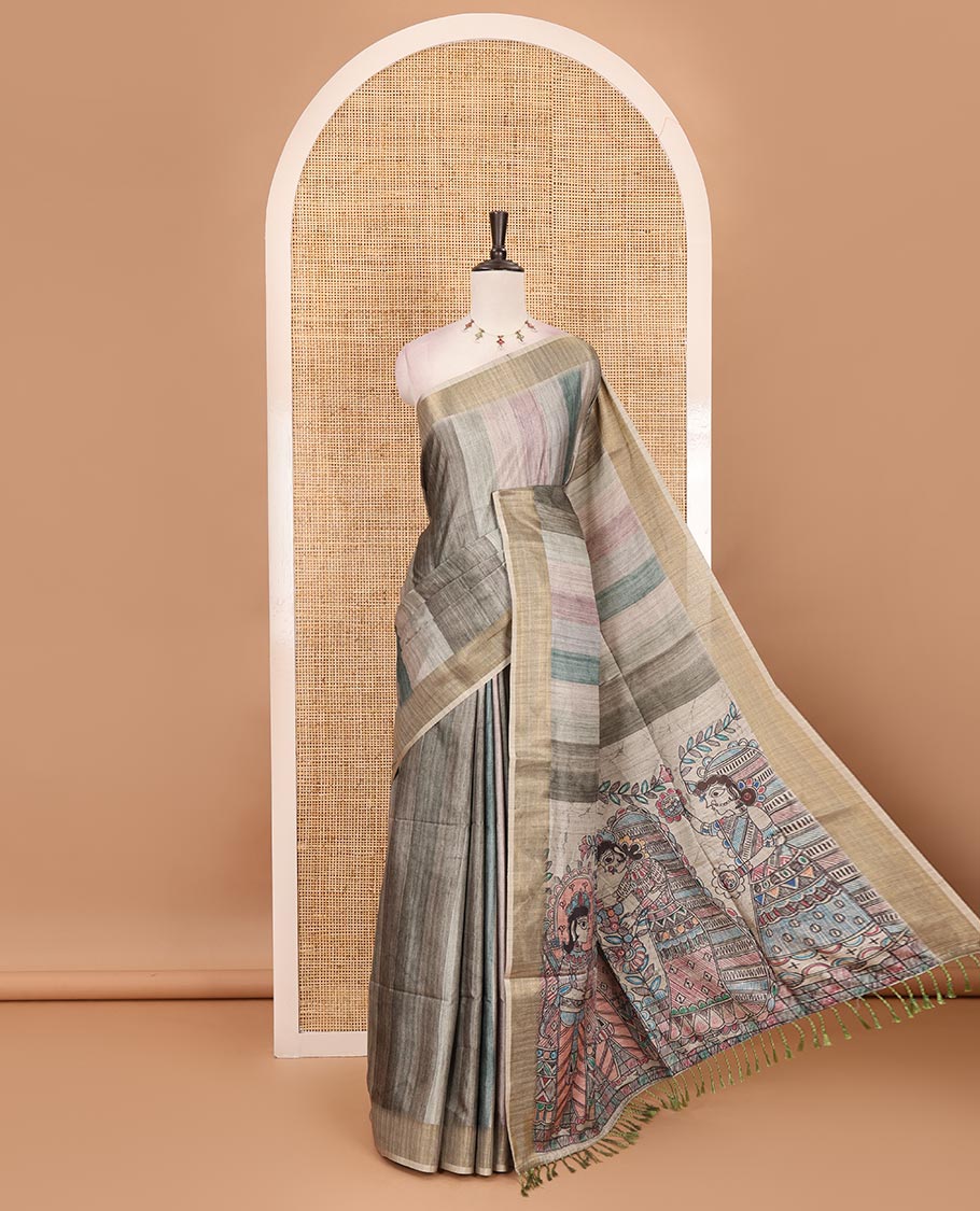 Green vertical stripes printed hand-brush dyed Katan silk saree, gold zari bavanji border, Madhubani-style human figurines printed pallu, and floral printed blouse