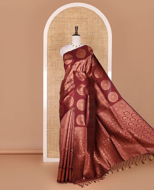 Maroon jacquard kanchi tissue saree, zari chakram motifs border, intricately zari woven pallu, and a matching zari design blouse