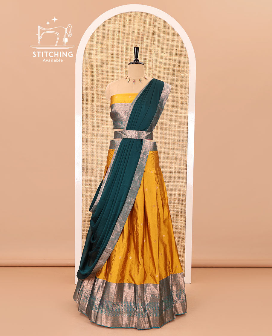 Mustard-rama taffeta half-saree, zari buttas with contrast traditional zari bordered skirt, a matching blouse, and contrast zari border dhavani with belt