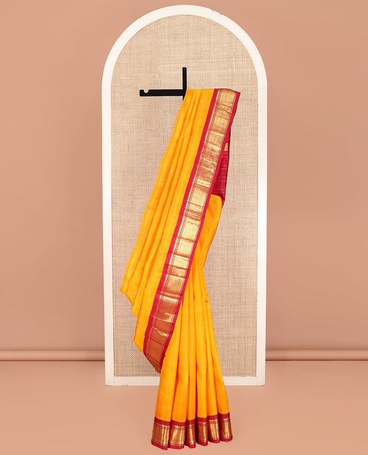 Yellow Kanchipuram Silk Saree, Sparsely Woven with Zari Buttas on Its Body, Complemented by Contrast One-Sided Korvai Border of Thilakam Mokku, Banaras, and Jaal Designs, Pallu Features Zari Designs, and Comes Without a Blouse
