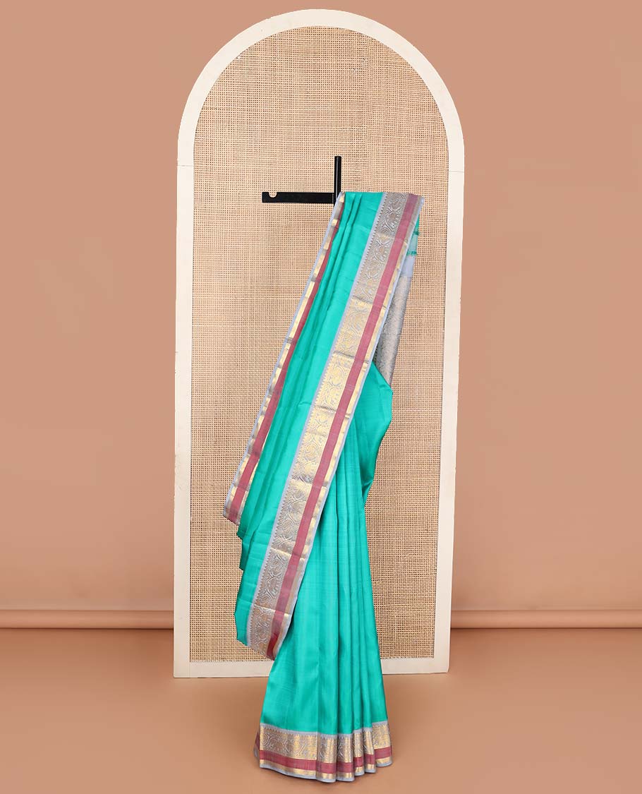 Turquoise plain Kanchipuram korvai silk saree, contrast neer korvai border of rekku, muthu, banaras, and kodi mayil and yaanai designs, and floral jaal pallu
