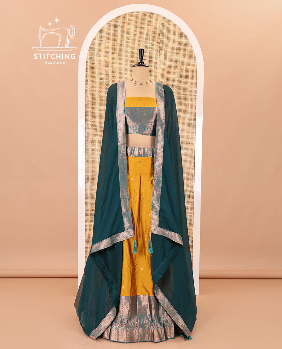 Mustard-rama taffeta half-saree, zari buttas with contrast traditional zari bordered skirt, a matching blouse, and contrast zari border dhavani with belt