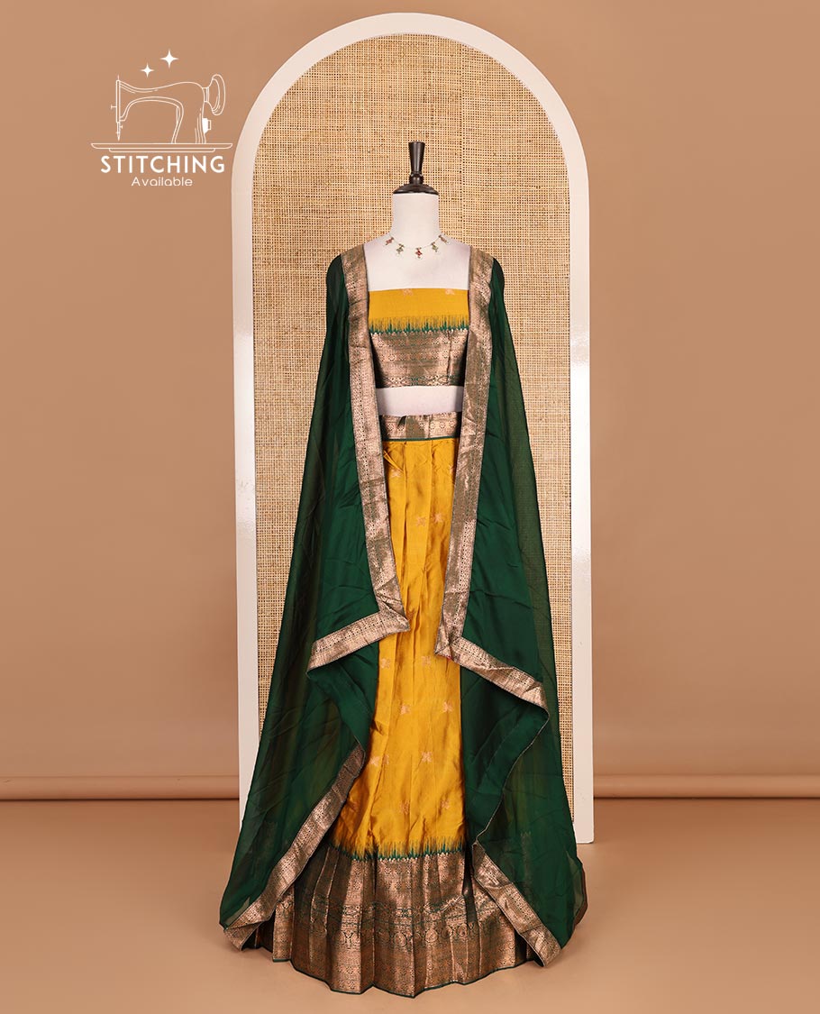 Mustard taffeta silk half saree, zari buttas with contrast green traditional zari border skirt, matching zari design blouse, and contrast plain zari border syska georgette dhavani