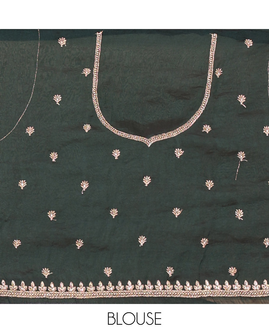 Bottle green half-saree, buttas and flora-fauna embroidered bordered velvet organza skirt, a matching velvet organza blouse, and a contrast embroidered scallop syska georgette dhavani