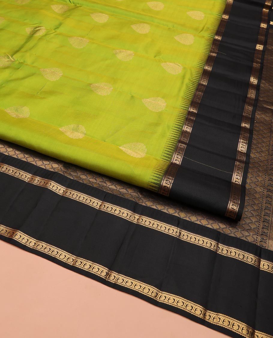 Green Vasundhara Silk Saree, Detailed with Zari Buttas on Its Body, Complemented by Contrast Temple Border of Banaras, Kathir, and Manga Designs, Grandly Woven Jaal Pallu, and Paired with a Contrast Blouse
