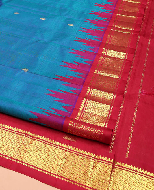 Blue Kanchipuram Silk Saree, Beautifully Bedecked with Zari Buttas, Complemented by Contrast One-Sided Border of Thazampoo Rekku, Thilakam Mokku, and Jaal Designs, Pallu of Zari Designs, and Comes Without a Blouse