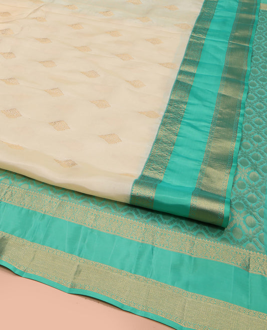 Cream Vasundhara Lite Silk Mix Saree, Gracefully Embellished with Zari Buttas All Over Its Body, Complemented by a Contrast Rettai Pettu Border of Thilakam Mokku, Kodi Visiry, and Kamalam Designs, Grand Jaal Design Pallu, and Paired with a Contrast Blouse