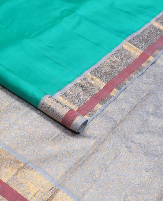 Turquoise plain Kanchipuram korvai silk saree, contrast neer korvai border of rekku, muthu, banaras, and kodi mayil and yaanai designs, and floral jaal pallu