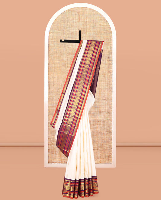 White Kanchipuram Silk Saree, Enthralled with Zari Buttas, a Contrast Korvai Border of Rekku, Muthu, Banaras, Poun, Mayil, Kathir, and Mayil Kann, Grand Pallu, and a Contrast Blouse