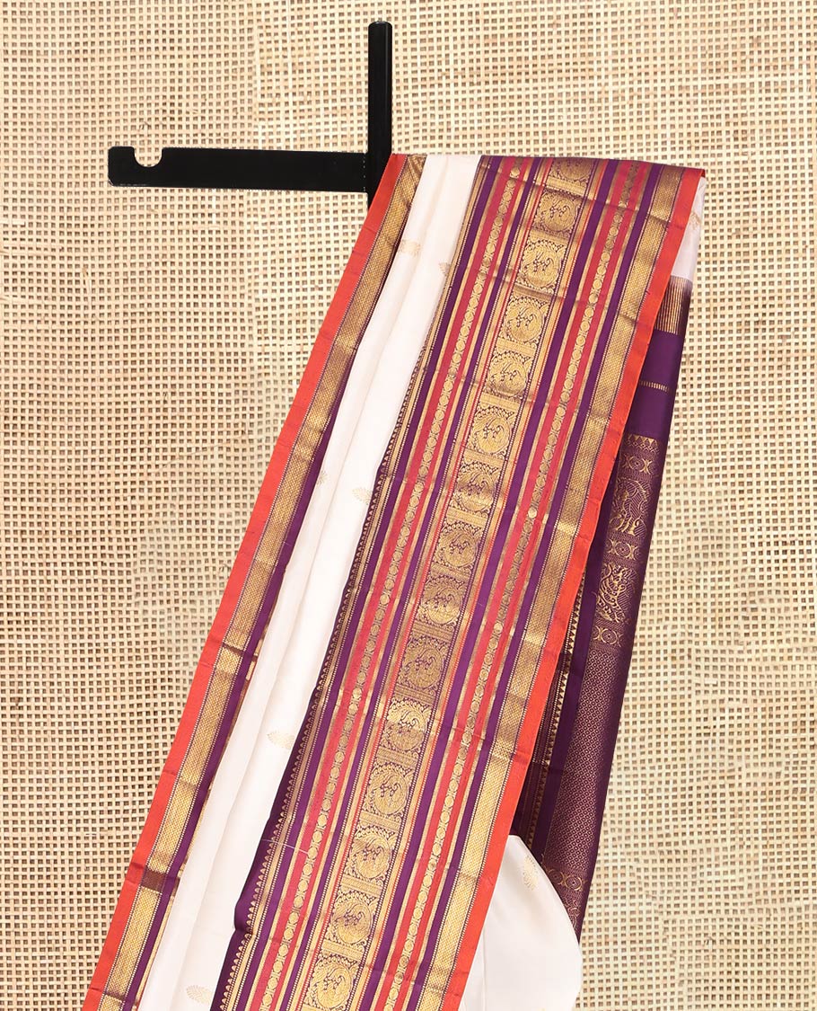 White Kanchipuram Silk Saree, Enthralled with Zari Buttas, a Contrast Korvai Border of Rekku, Muthu, Banaras, Poun, Mayil, Kathir, and Mayil Kann, Grand Pallu, and a Contrast Blouse