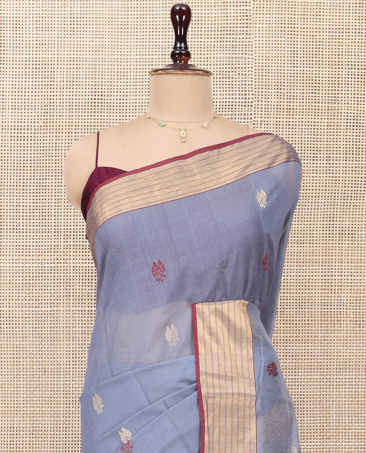Grey Chanderi Cotton Saree, Delicately Woven with Leaf Buttas All Over Its Body, Complemented by a Contrast Zari Striped Border, Complemented by Contrast Pallu of Leaf Designs, and Paired with a Contrast Blouse