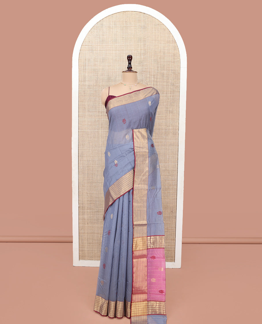 Grey Chanderi Cotton Saree, Delicately Woven with Leaf Buttas All Over Its Body, Complemented by a Contrast Zari Striped Border, Complemented by Contrast Pallu of Leaf Designs, and Paired with a Contrast Blouse
