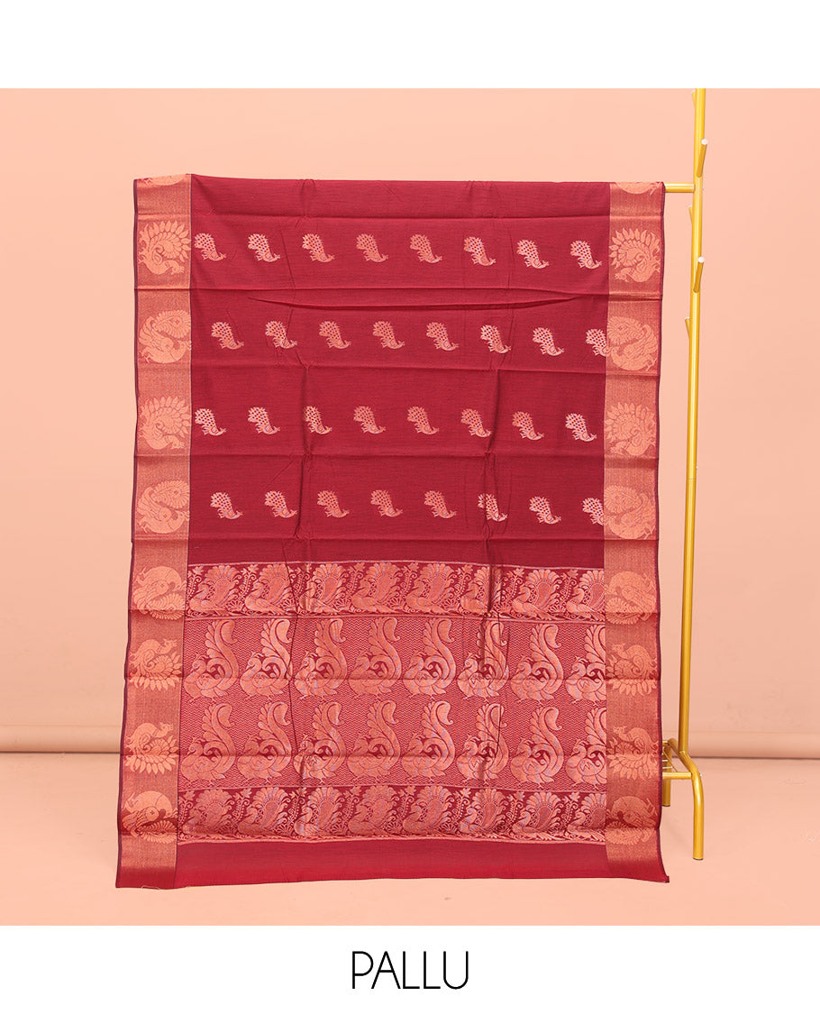 Maroon Semi-Silk Cotton Saree, Ornamented with Peacock Buttas All Over Its Body, Highlighted by a Zari Border of Peacock Designs, Pallu Steeped with Peacock Zari Motifs, and Paired with a Matching Blouse